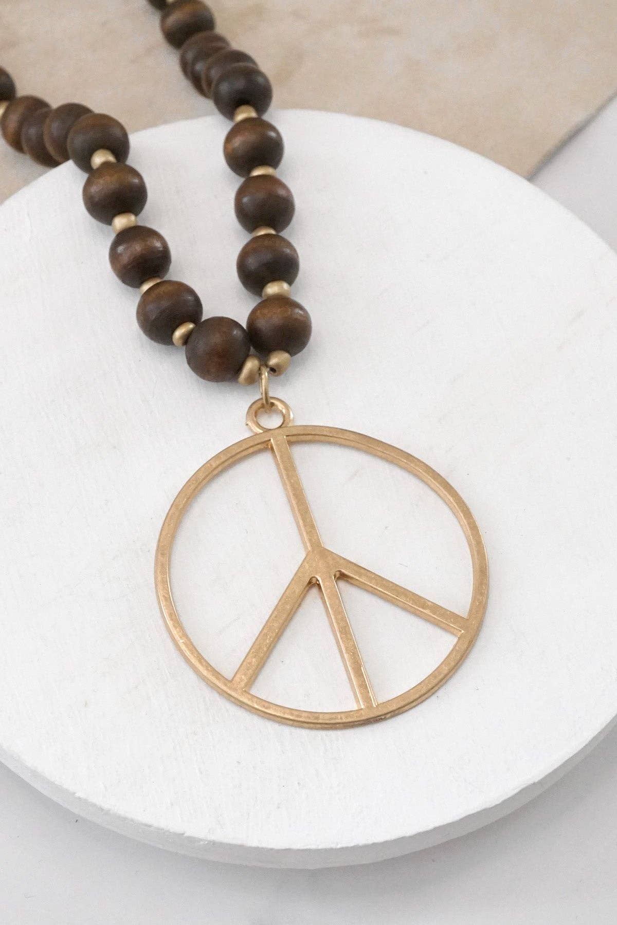 Long Wood Bead Necklace with golden peace sign pendant - Brown
